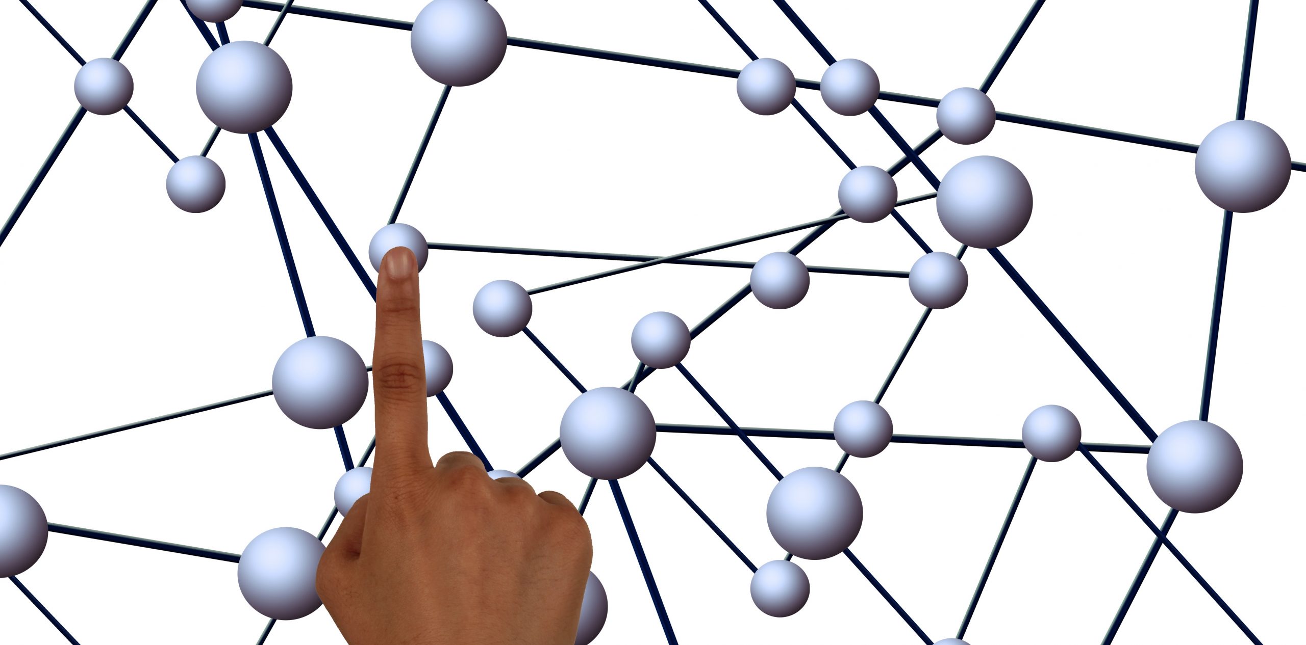 A person's index finger pressing on a proton particle.