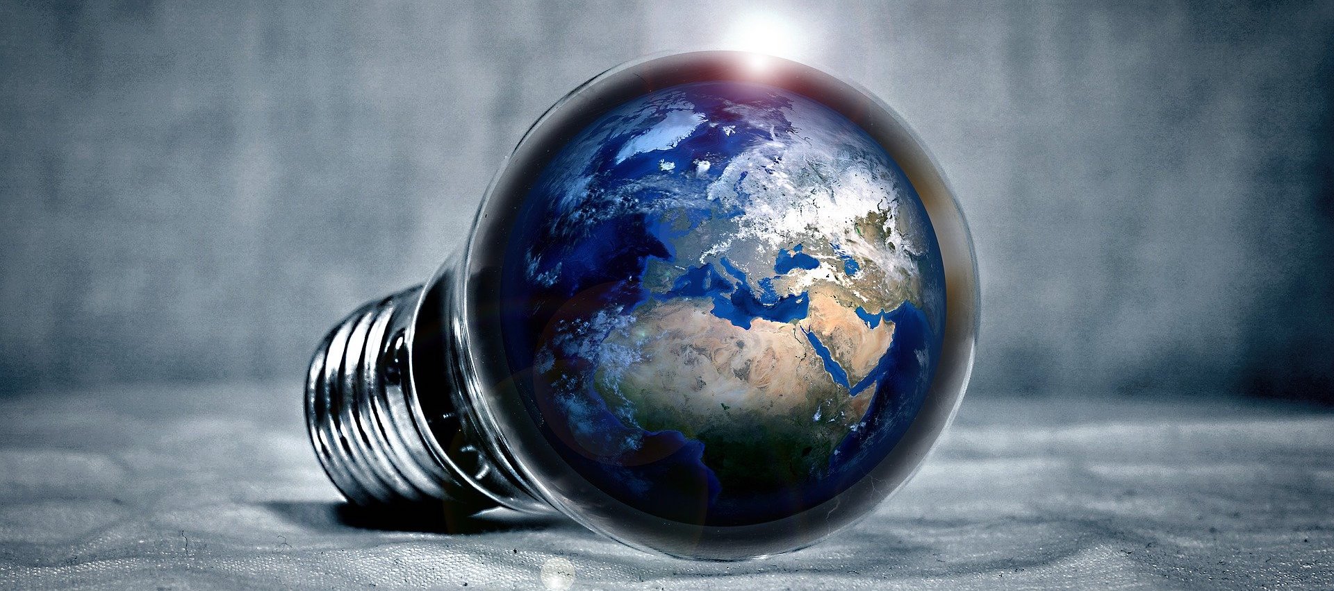 Image of a lightbulb with the earth inside of it.