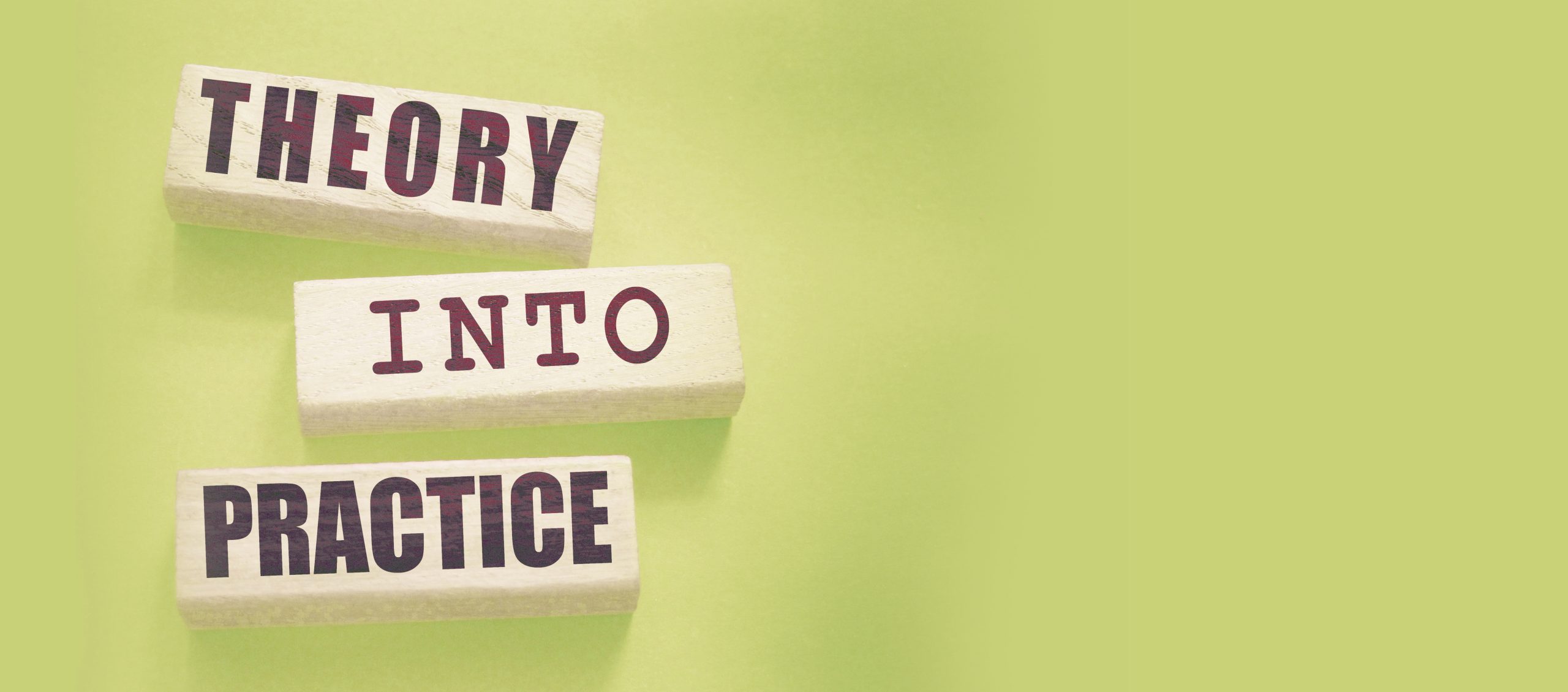 Theory into practice words written on wooden blocks.