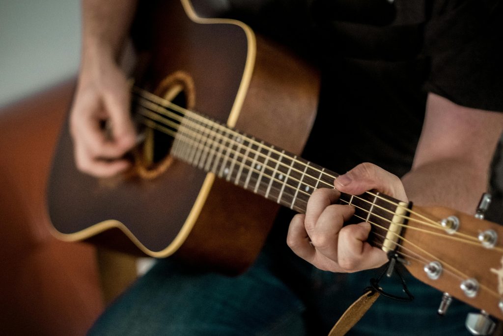 photo of an acoustic guitar being played