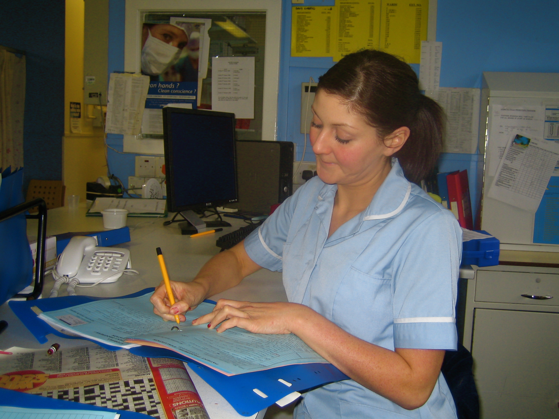 Nurse writing at a desk
