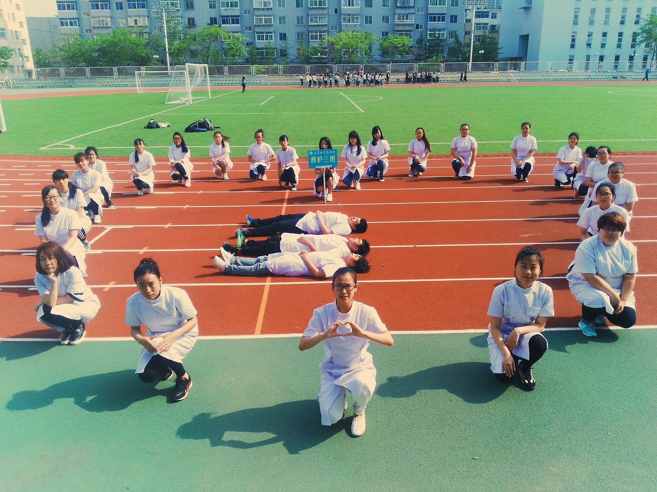 Nursing Students in a field making a large heart shape