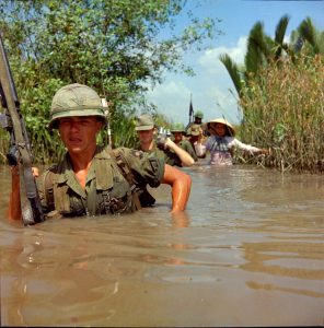 Photograph of Private Fred L. Greenleaf Crossing a Deep Irrigation Canal during Operation Bang Dong