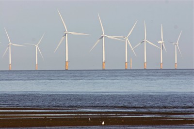Photograph of wind turbines at sea.