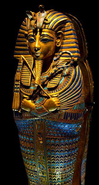 The canonic coffinette of king Tutankhamen stands up with light directly on the head and shoulders of the figure depicted and shines with gold and colored inlay.