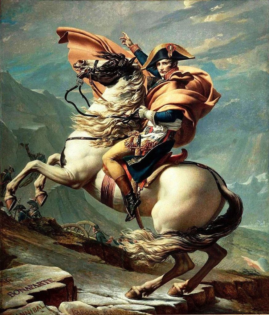 Bonaparte has an orange cloak, the crispin (cuff) of his gauntlet is embroidered, the horse is piebald, black and white, and the tack is complete and includes a standing martingale. The girth around the horse's belly is a dark faded red. The officer holding a sabre in the background is obscured by the horse's tail. Napoleon's face appears youthful.